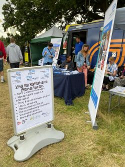 wellness on wheels bus offering health advice to festival goers