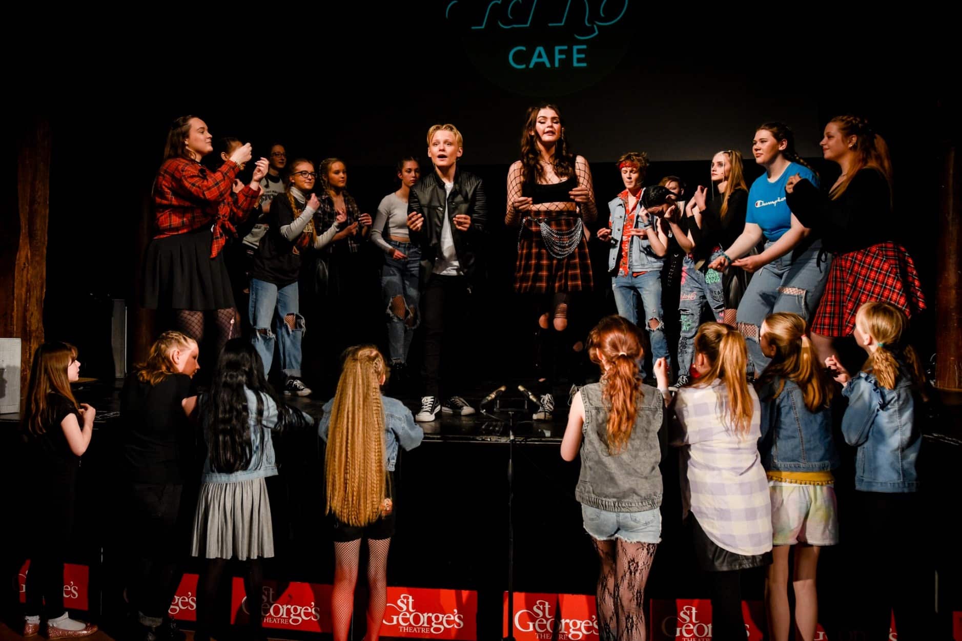 Group of young people on stage performing