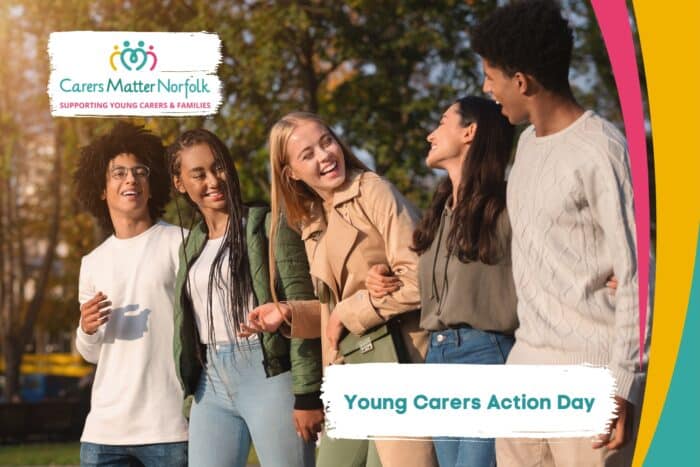 Group of young people smiling. The text on the photo says 'Young Carers Action Day'.