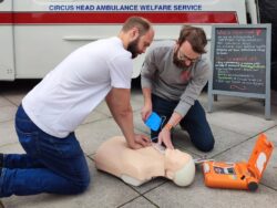 two people conducting CPR on mannequin